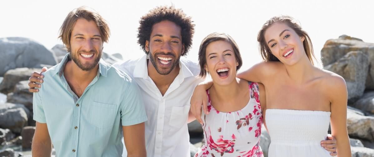 Ocean Hills Dentistry Services for Everyone A decorative image of friends smiling together on the beach.